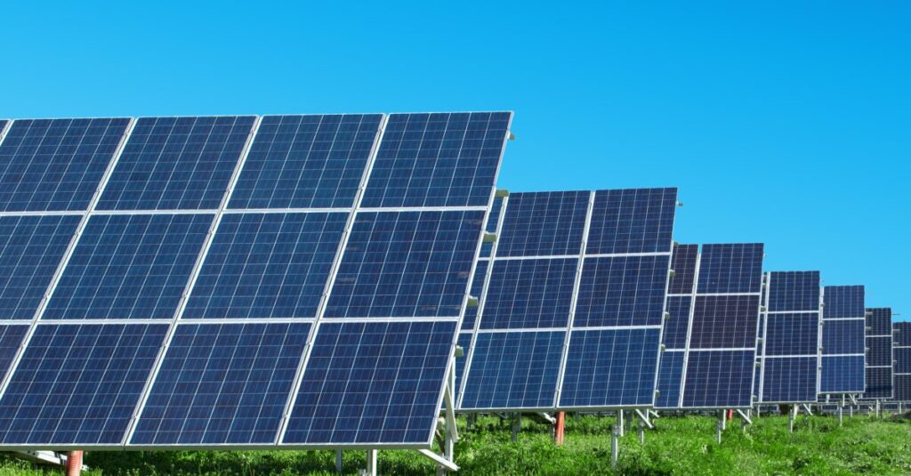 A solar farm generating electricity under a clear blue sky.